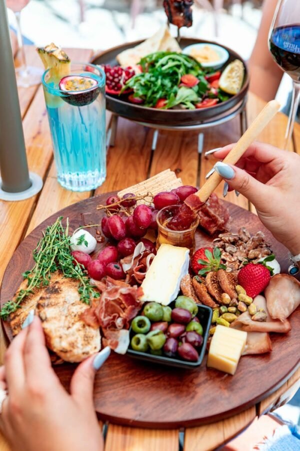 Vibrant charcuterie board with an assortment of meats, cheeses, fruits, and olives, perfect for gourmet dining.